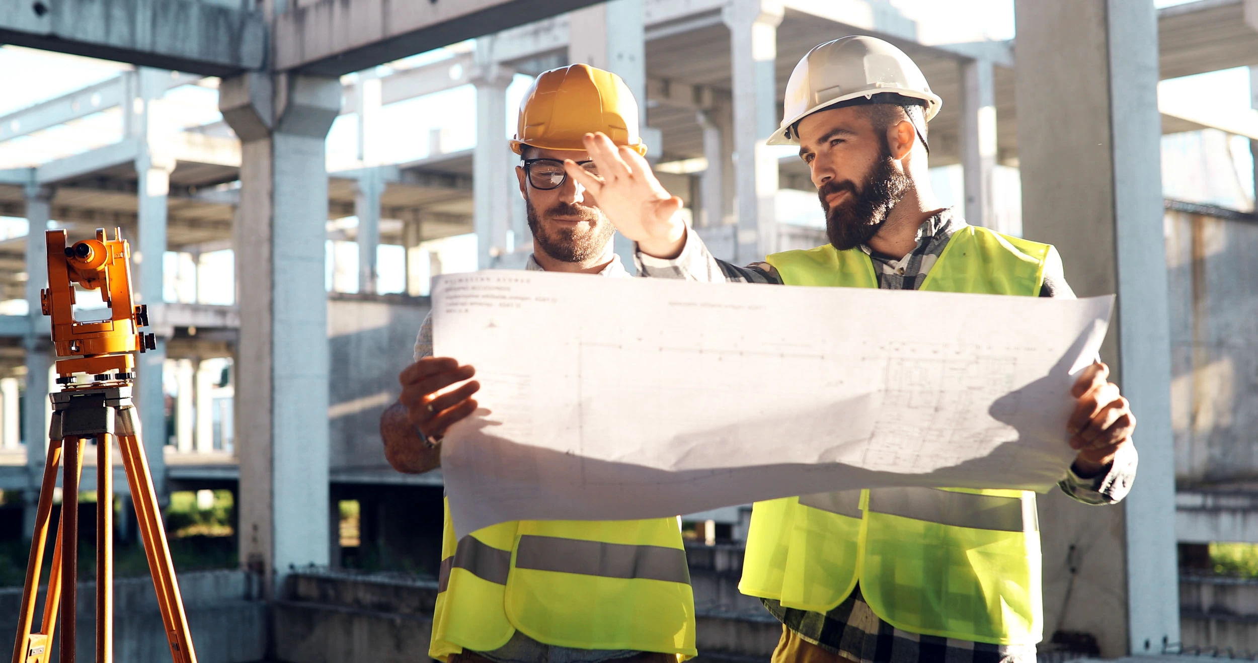 Skills Solutions Group Ltd Website Why Choose Us with construction workers on site reading plans and managing
