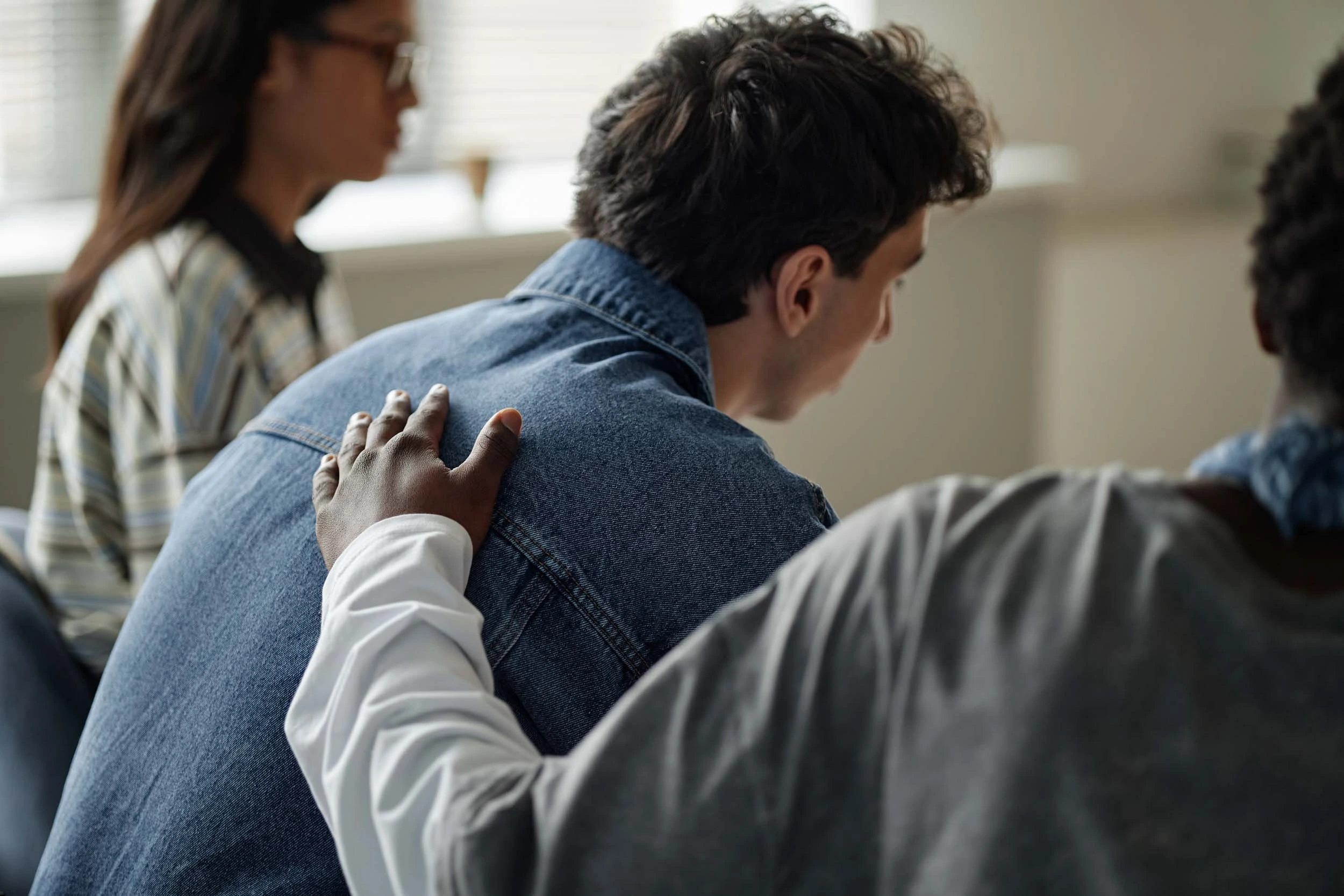 Construction workers digging on a construction site next to an excavator